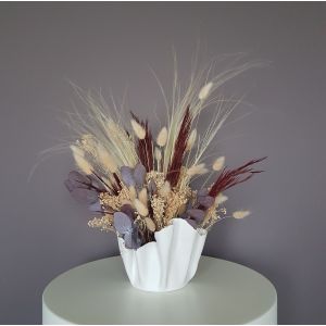 dried flower arrangement in white vase. bunny tails, dried eucalyptus and feather grass