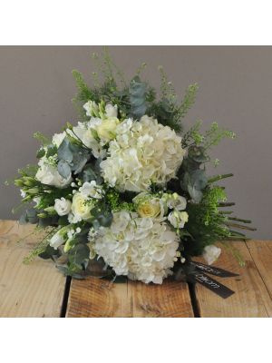 bouquet of white hydrangeas, white roses and white lisianthus