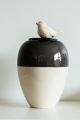 Reflection is a handmade vase half cream and half grey with a 3D bird on the rim. 